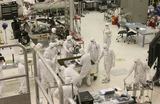 Picture of people in white cleanroom suit in a cleanroom at JPL assembling a Mars rover